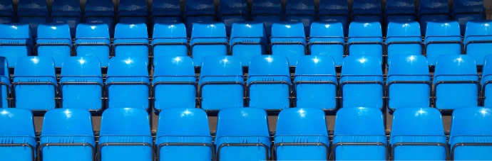 Rows of empty blue seats.